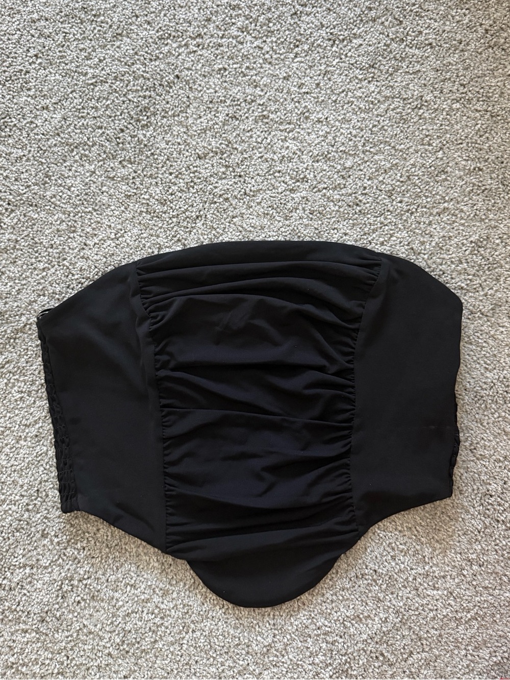 Woman’s black strapless top
